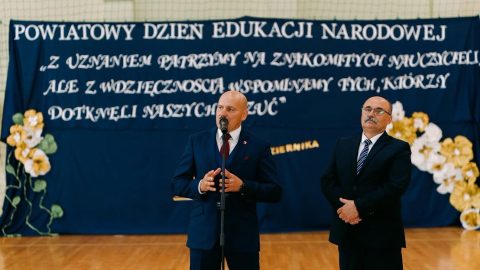 Wicestarosta Jarosław Korzeń przemawia do zgromadzonych podczas Powiatowego Dnia Edukacji Narodowej. Obok niego stoi Dariusz Czop, członek Zarządu Powiatu Tomaszowskiego.